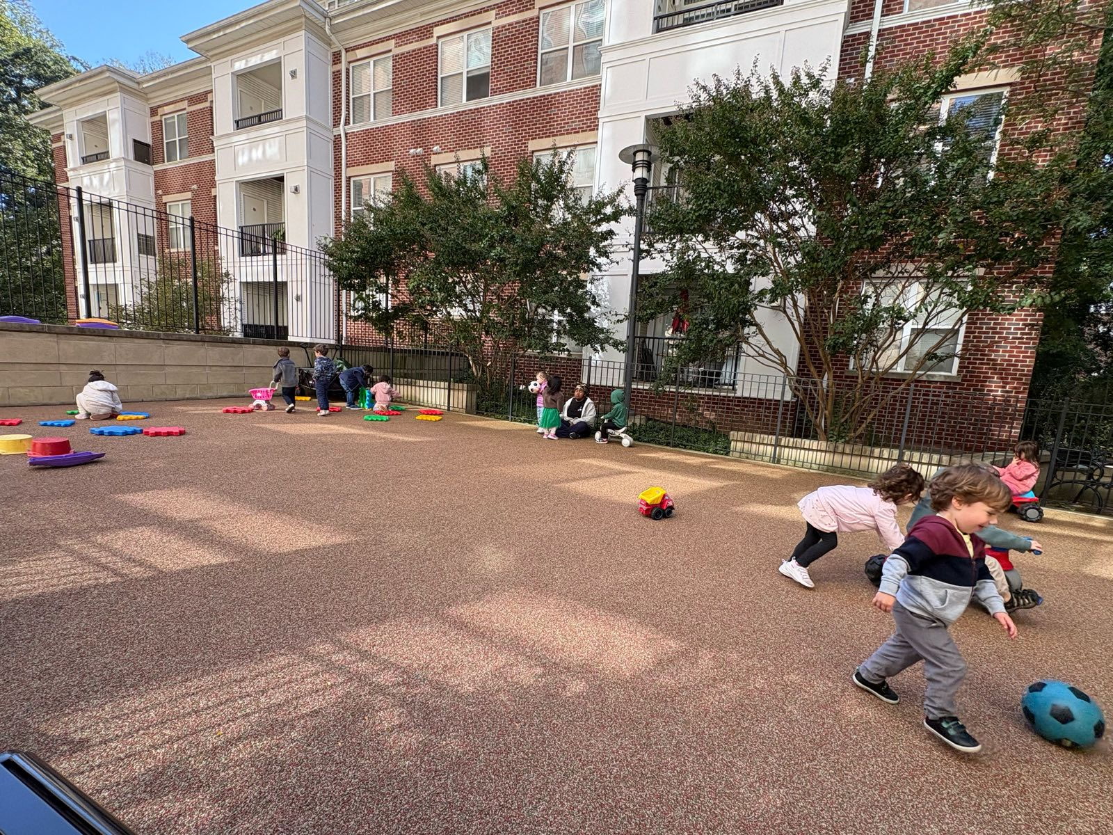 Children playing ball in the outdoor courtyard